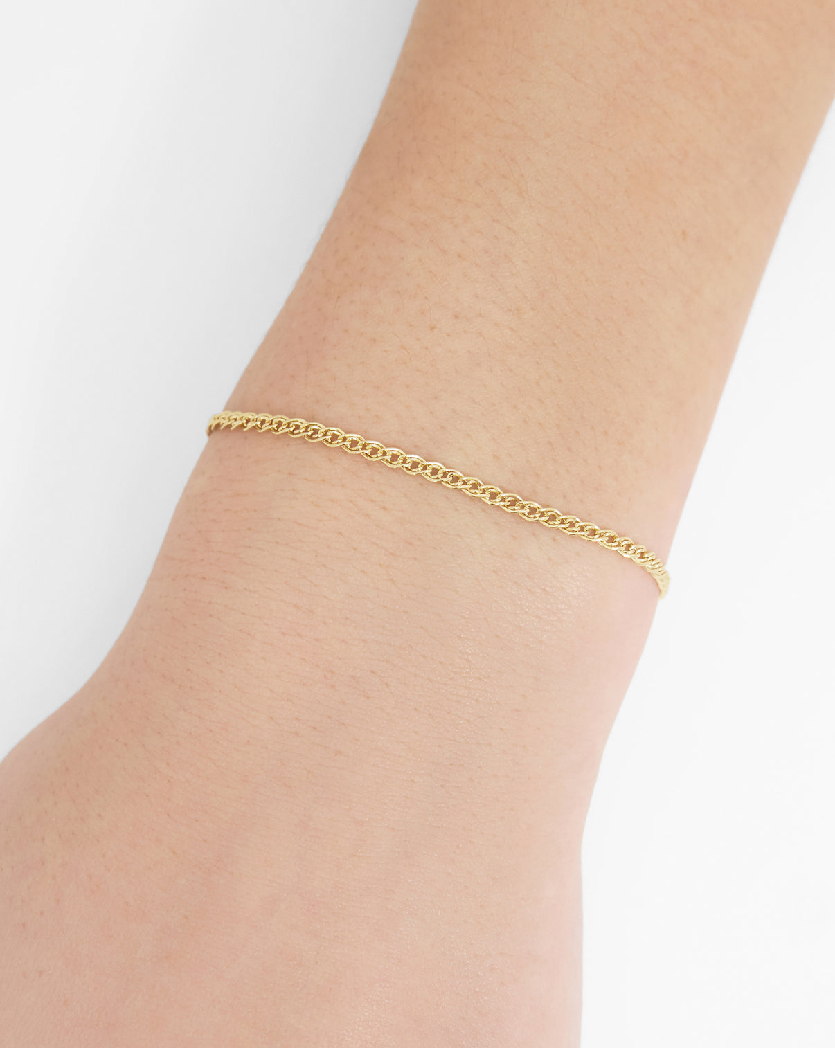 Petite Twin Chain Bracelet in 14k solid gold worn on model's wrist.