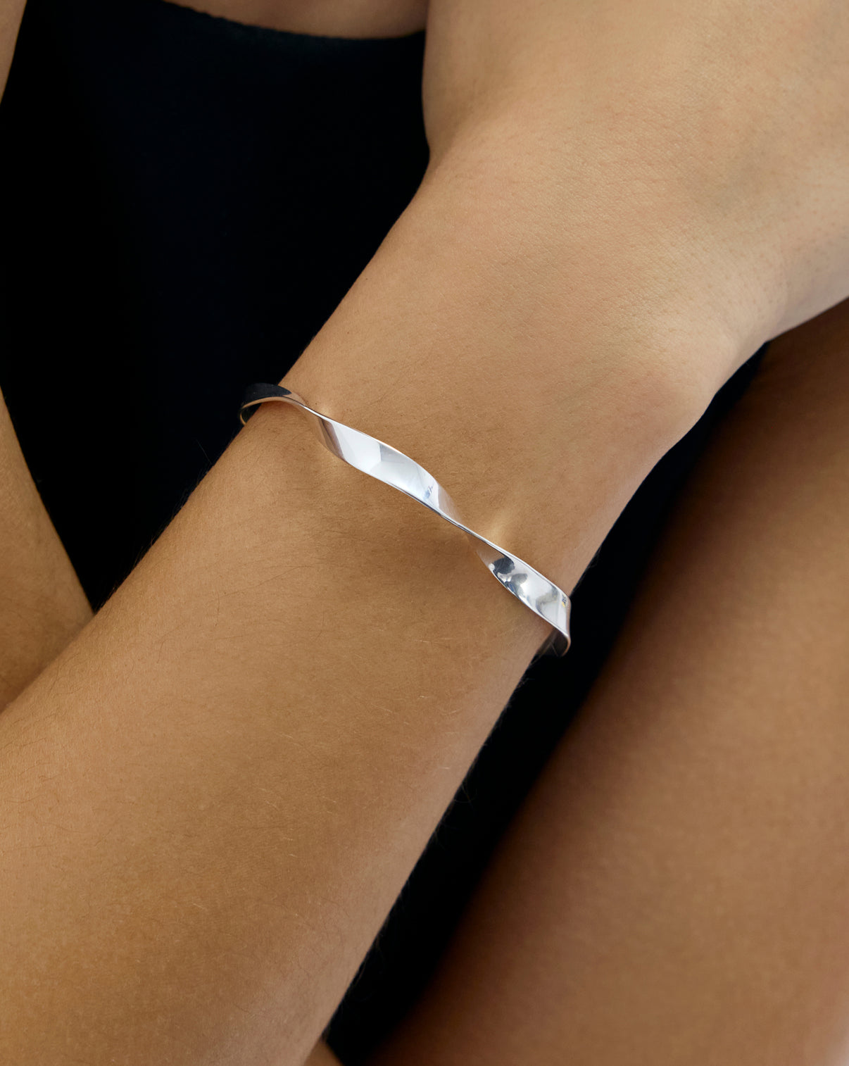 Close up Silver Twist Cuff on model's wrist