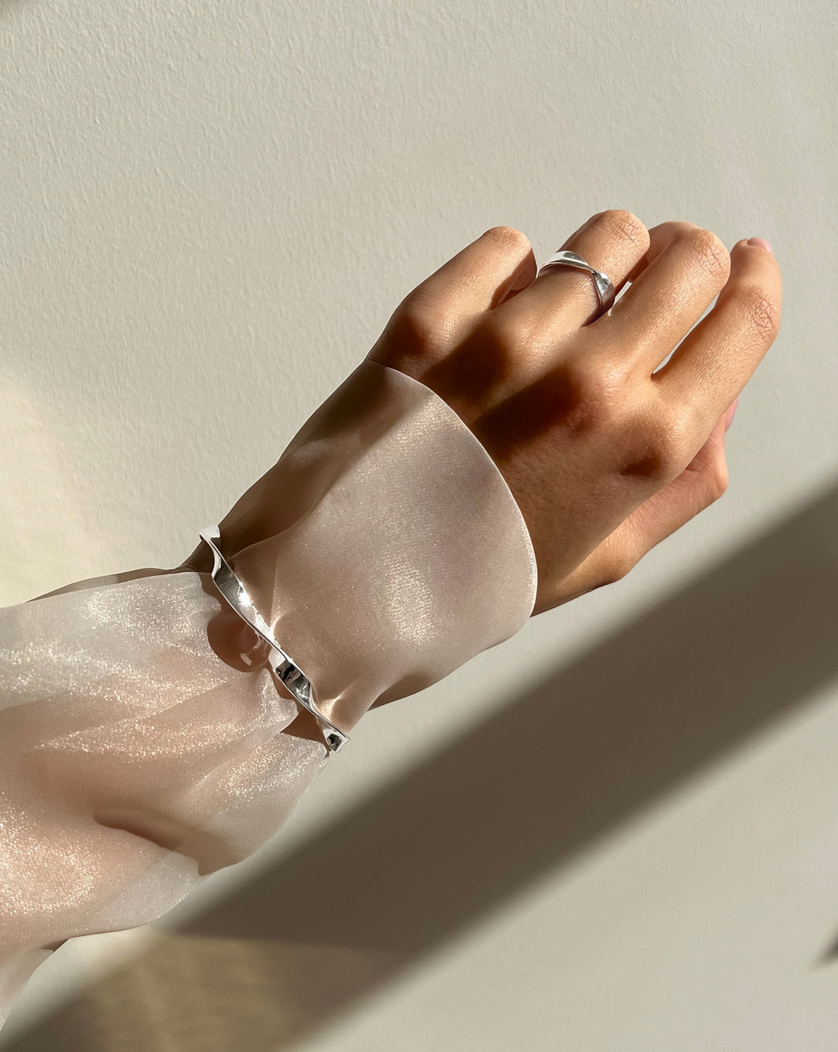 Silver Twist cuff styled over a sheer long sleeve 
