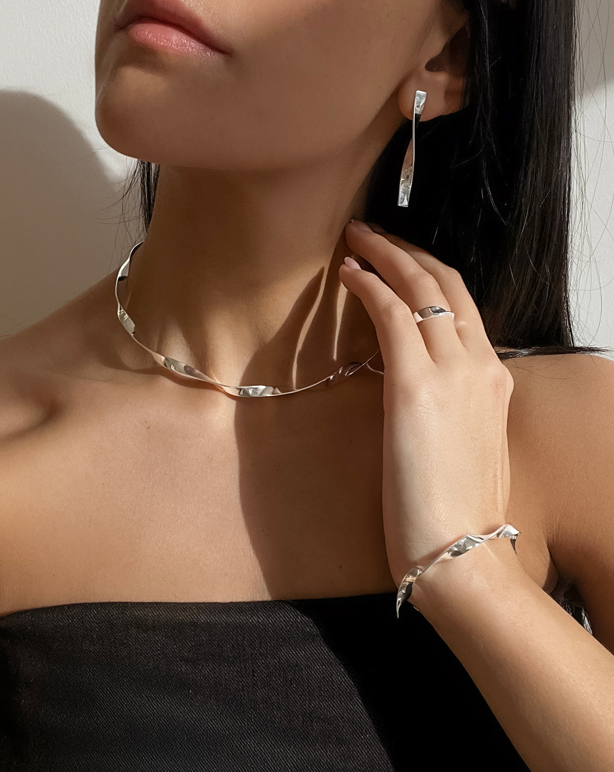 Silver Twist earrings, collar necklace, and cuff shown on model