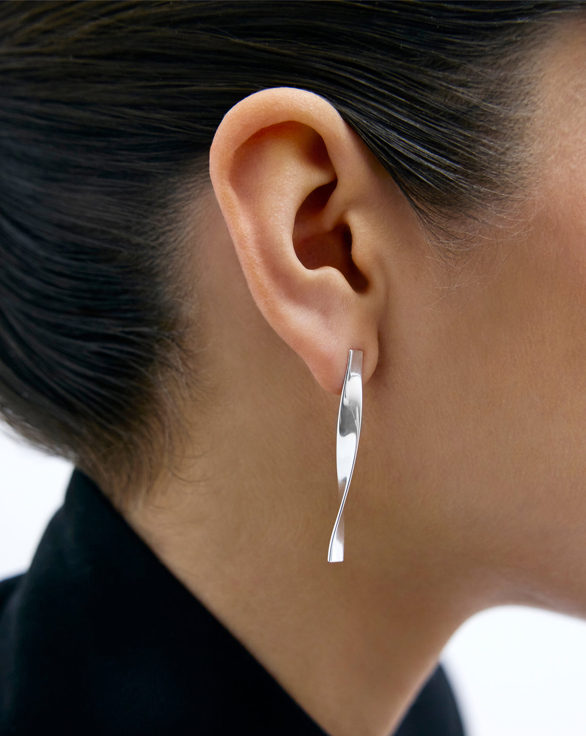 close up side profile Silver Twist  Earrings on model