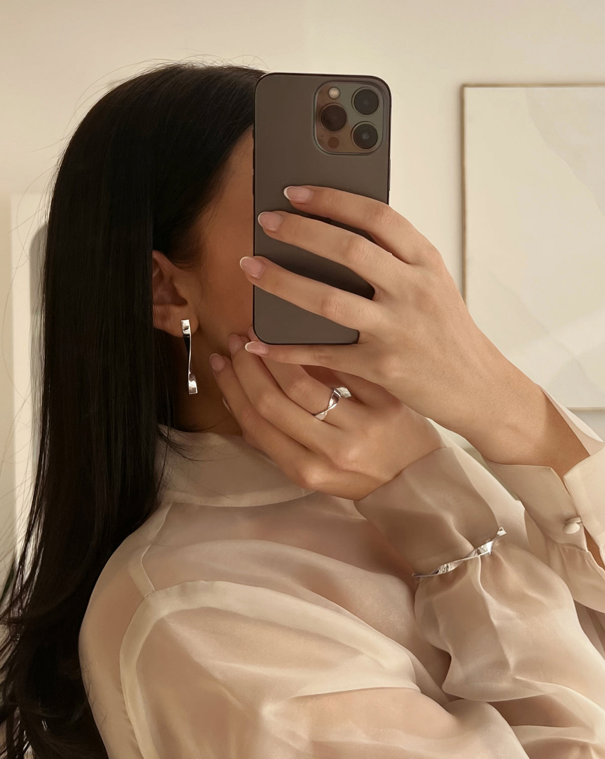 Photo of model wearing Silver Twist earrings, necklace and cuff