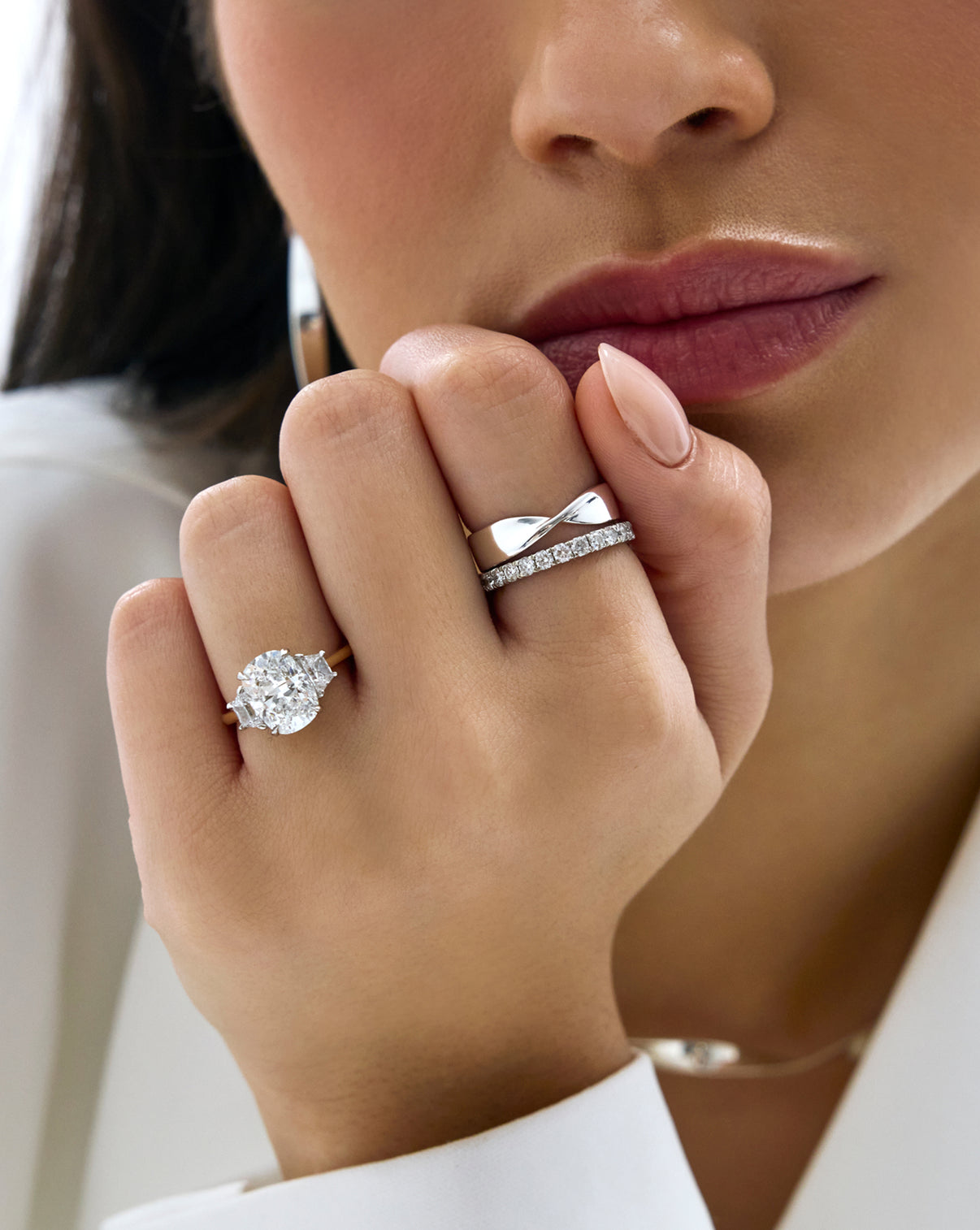 Silver Twist ring styled with a diamond band and diamond engagement ring on model's hand