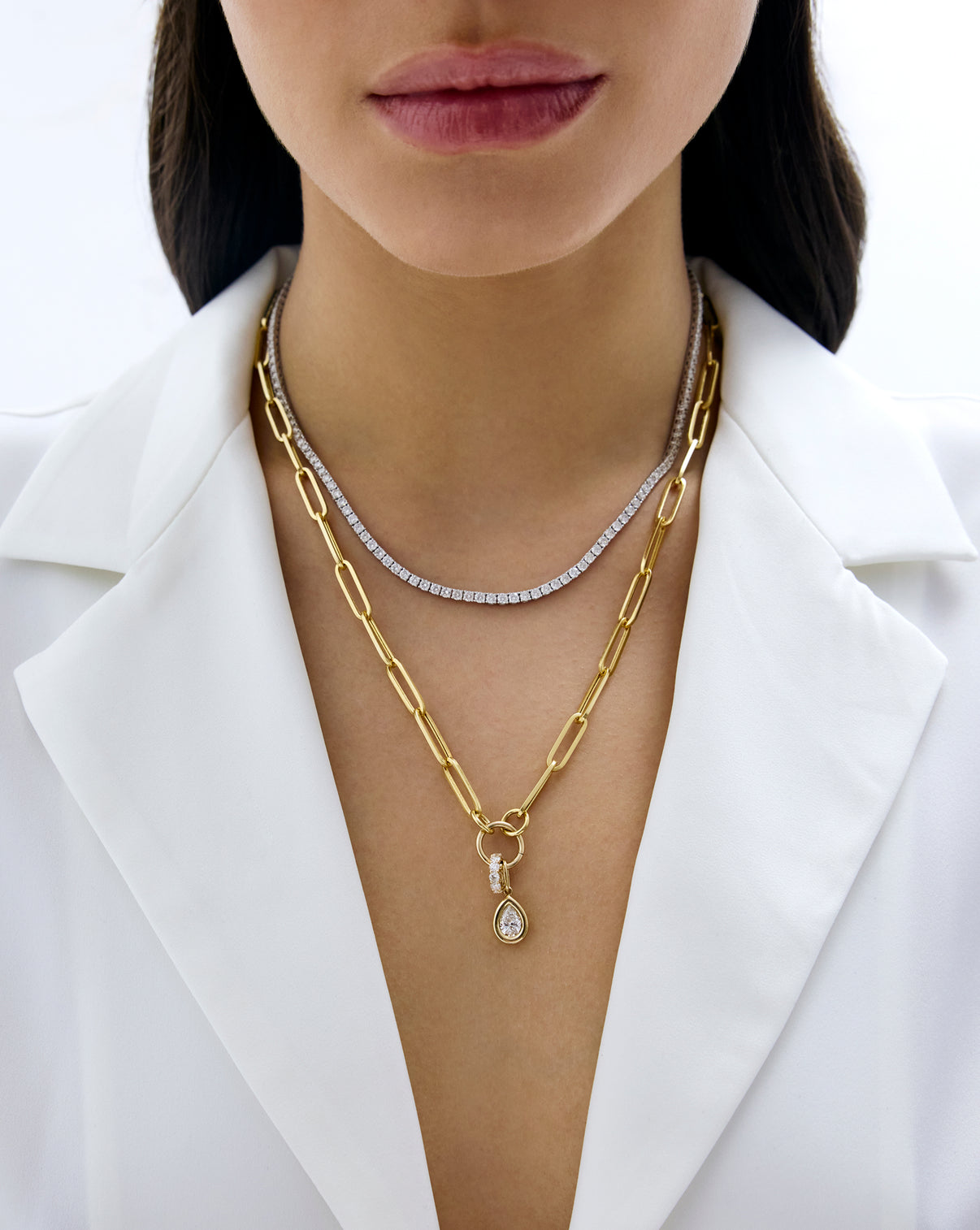 model wearing tennis necklace and Long Clique Chain Necklace with charms