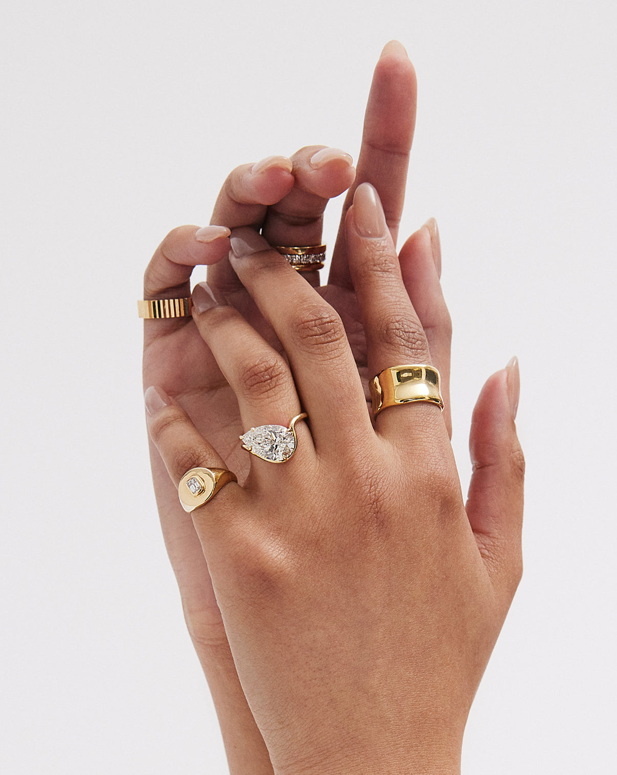model wearing Ring Concierge 4.32 Pear Lab Diamond in Curve Whisper Thin® 14K Yellow Gold Engagement Ring