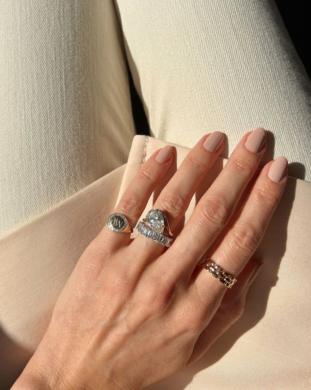 model wearing Ring Concierge 4.32 Pear Lab Diamond in Curve Whisper Thin® 14K Yellow Gold Engagement Ring styled with Eternity wedding band