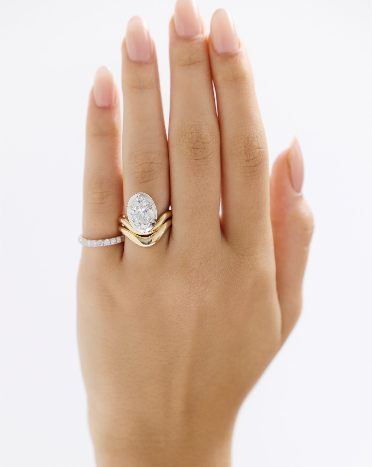 On-Model hand view of 3.07 Lab Grown Oval Curve Nest in Yellow Gold with Platinum Prongs with Curve Nest Wedding Band and Eternity Band

Nest Oval 14KY 43126398910552