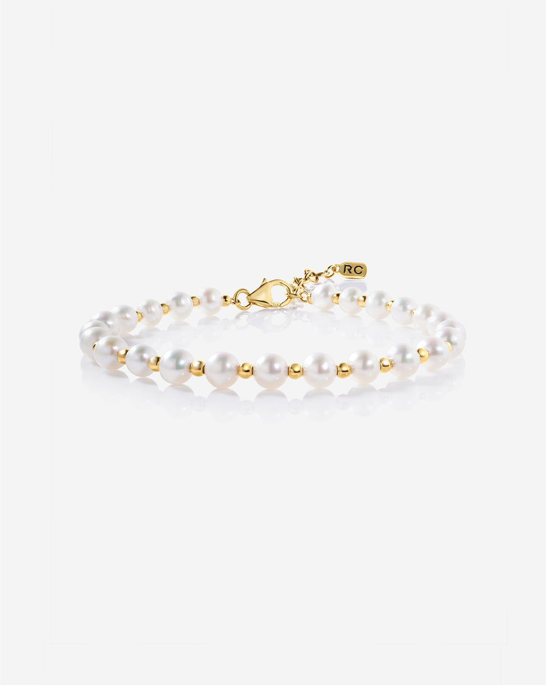 Pearl Station Bracelet featuring evenly spaced freshwater pearls on a delicate gold chain, displayed on a light background