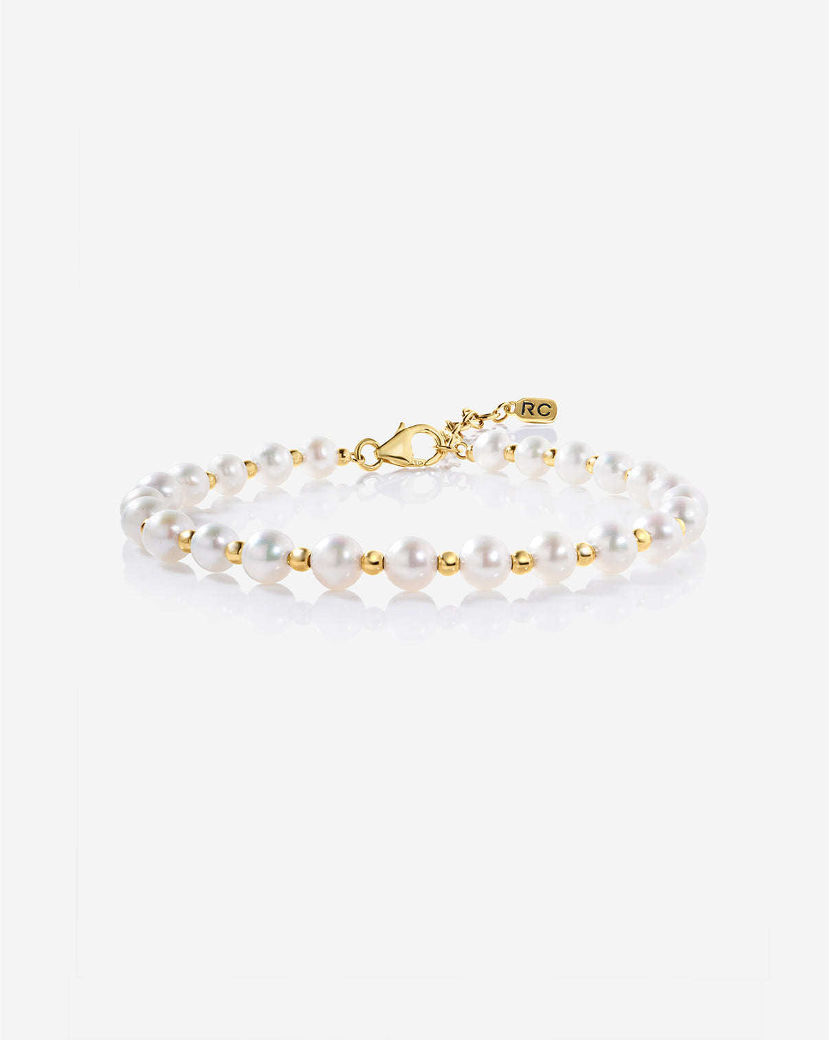 Pearl Station Bracelet featuring evenly spaced freshwater pearls on a delicate gold chain, displayed on a light background
