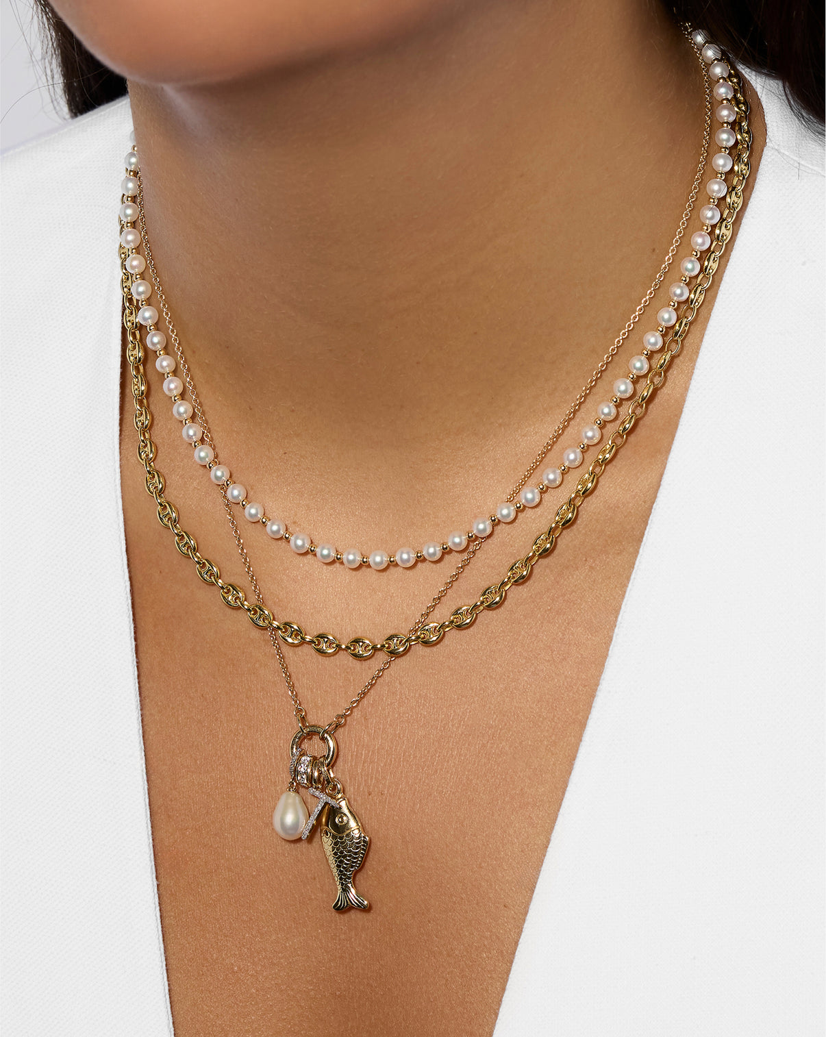 Side view of Pearl Station Necklace on model, demonstrating how it layers with other necklaces