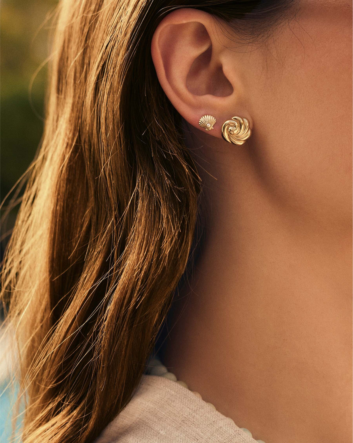 Swirling Studs worn on ear, demonstrating their lightweight and comfortable fit