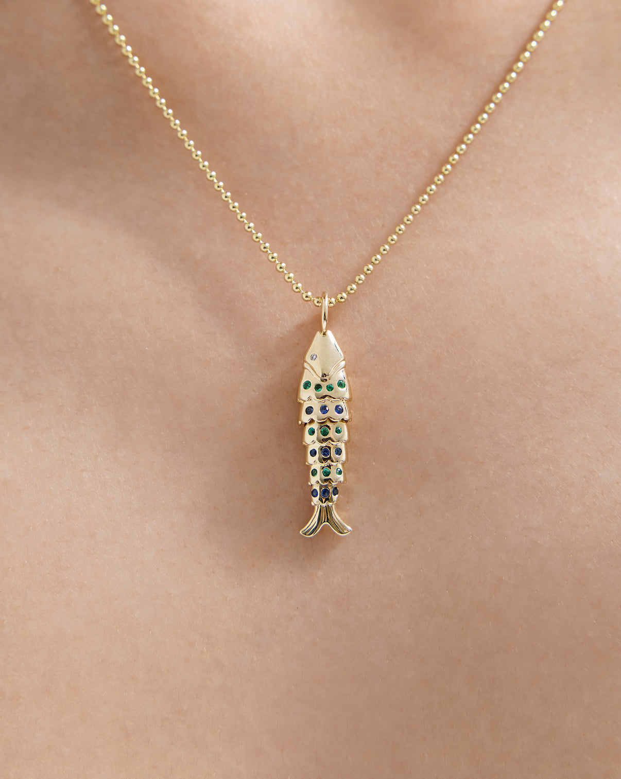 Close up of 14k solid gold Lucky Catch Pendant worn on gold chain