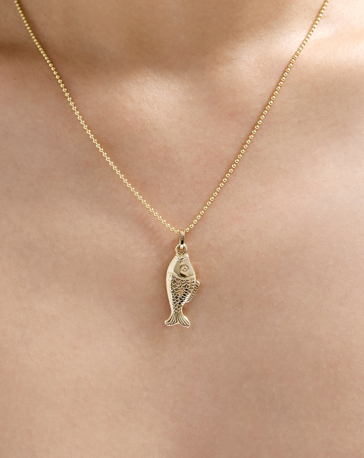 14k hollow gold Golden Catch Pendant worn on gold chain