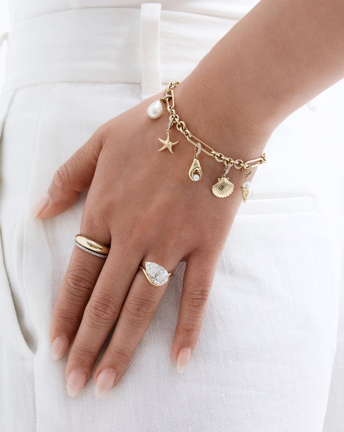 Sea Star Charm worn on gold bracelet by model