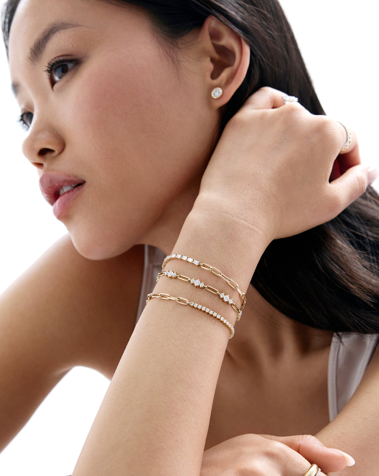Alternate image of model wearing all three styles of our new tennis chain bracelets including our Round, Graduated, and Baguette Lab Diamond Tennis Chain Bracelets