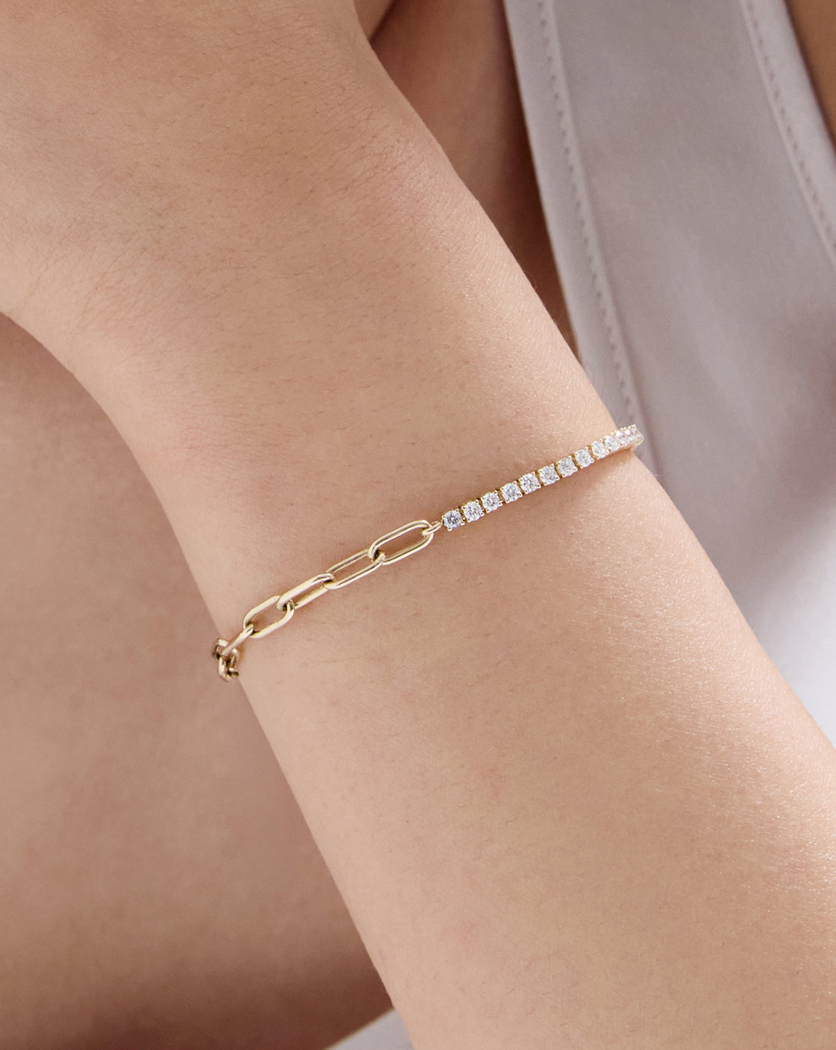 Close up of model wearing our 14k solid gold Round Lab Diamond Tennis Chain Bracelet on arm
