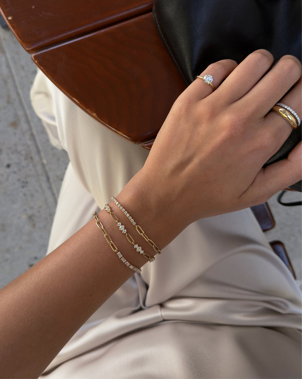 Model wearing all three styles of our new tennis chain bracelets including our Round, Graduated, and Baguette Lab Diamond Tennis Chain Bracelets