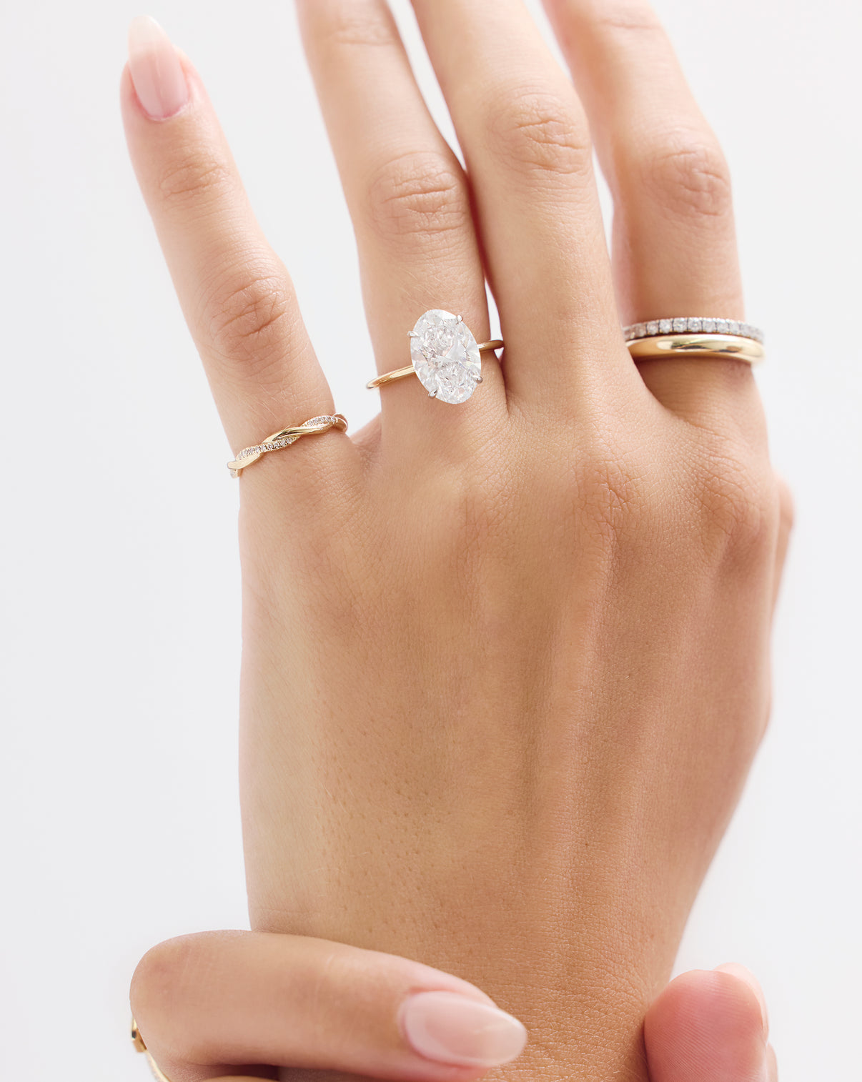 Close-up of diamond twist ring showing sparkling 0.5 carat total weight diamonds and intricate gold craftsmanship
