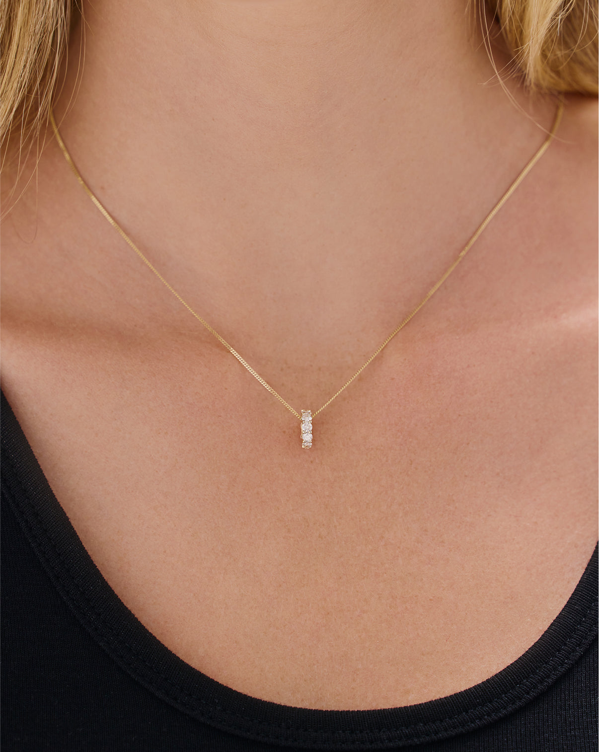 Round diamond bead charm worn on chain necklace showing elegant styling