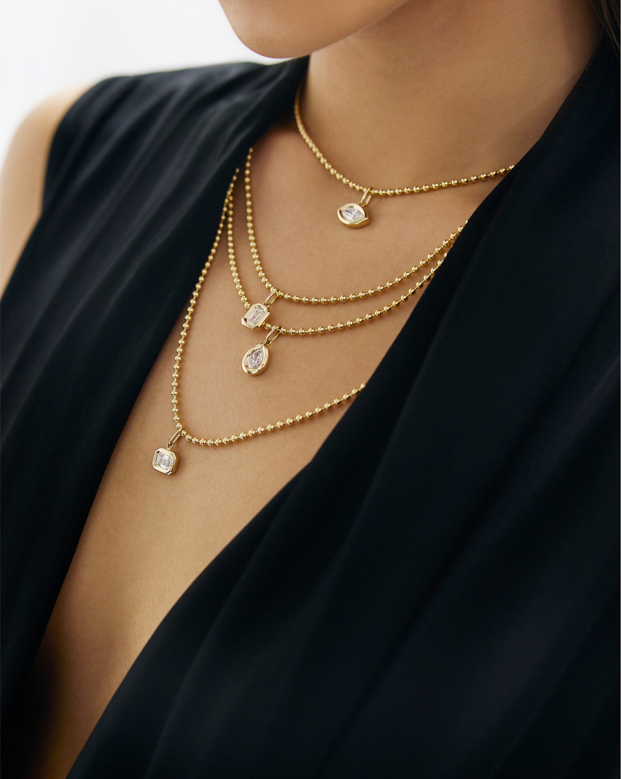 on-model with multiple necklaces and pendants layered global