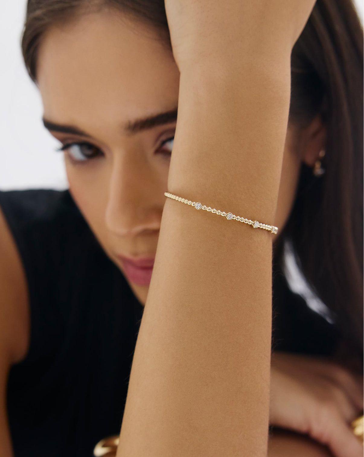 Ball diamond bangle worn on wrist, displaying elegant 14k gold craftsmanship
