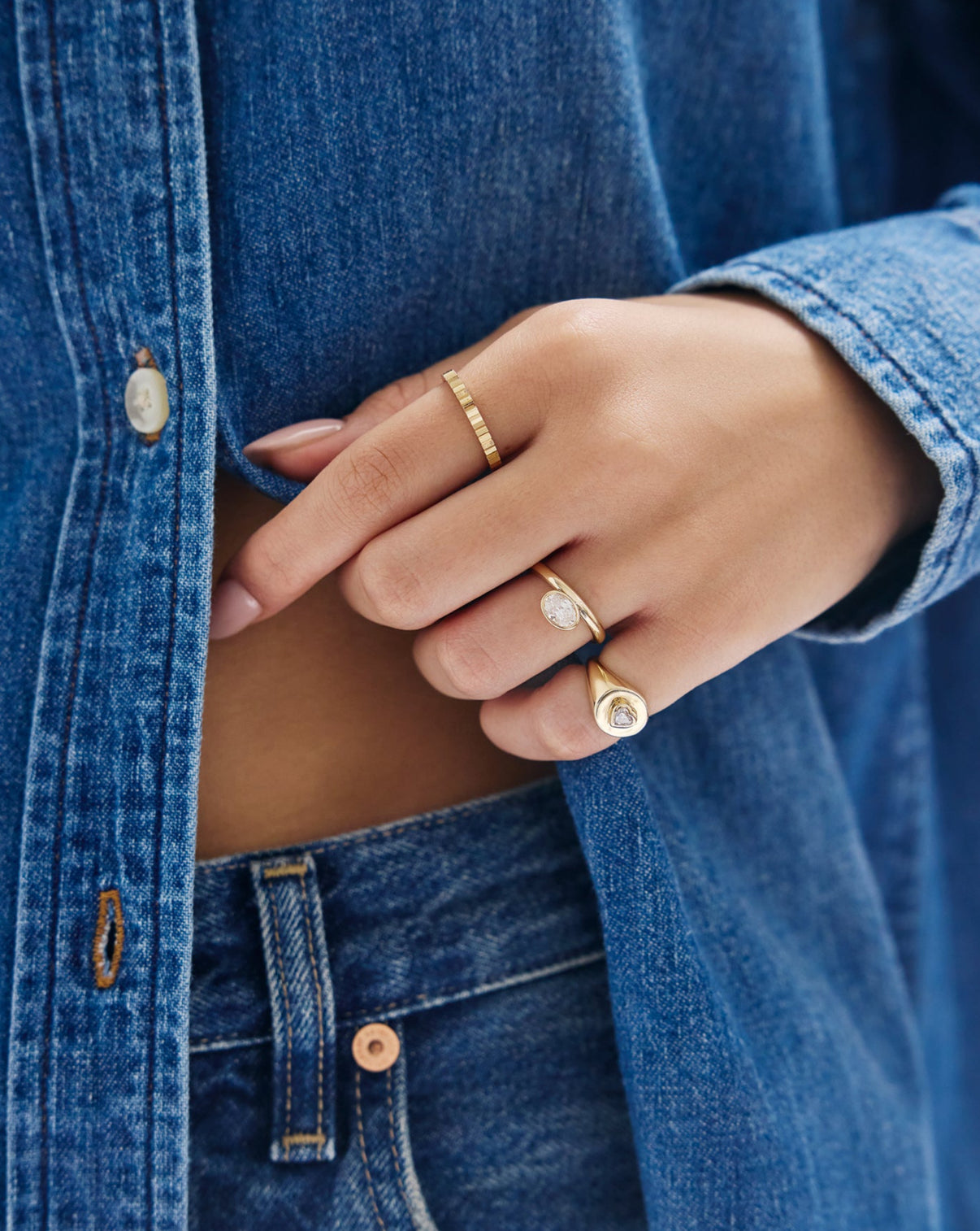 Close-up detail of oval bezel ring showing lab diamond clarity and smooth 14k yellow gold bezel setting
