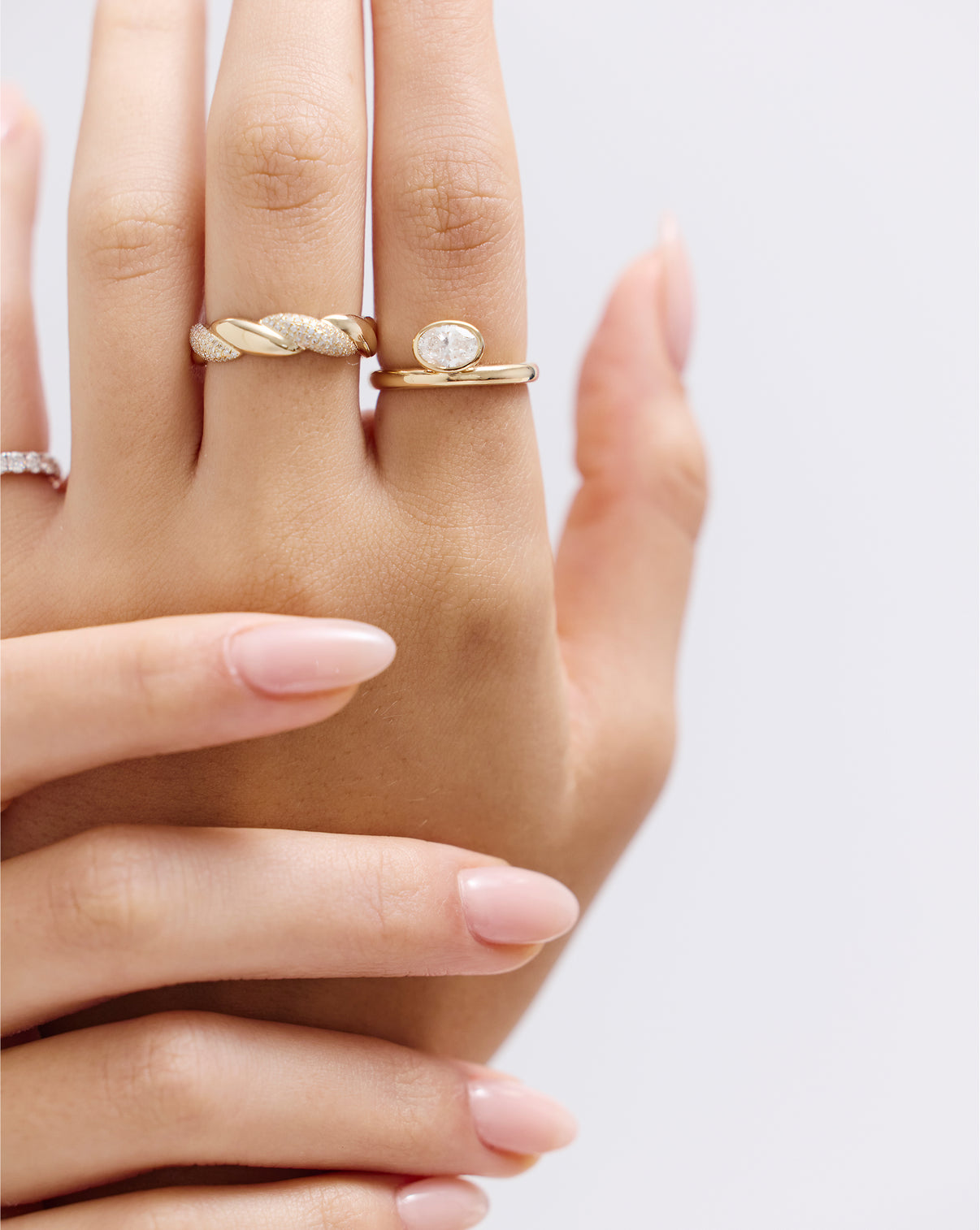 Top-down view of oval bezel ring highlighting the off-set oval lab diamond and modern gold band design