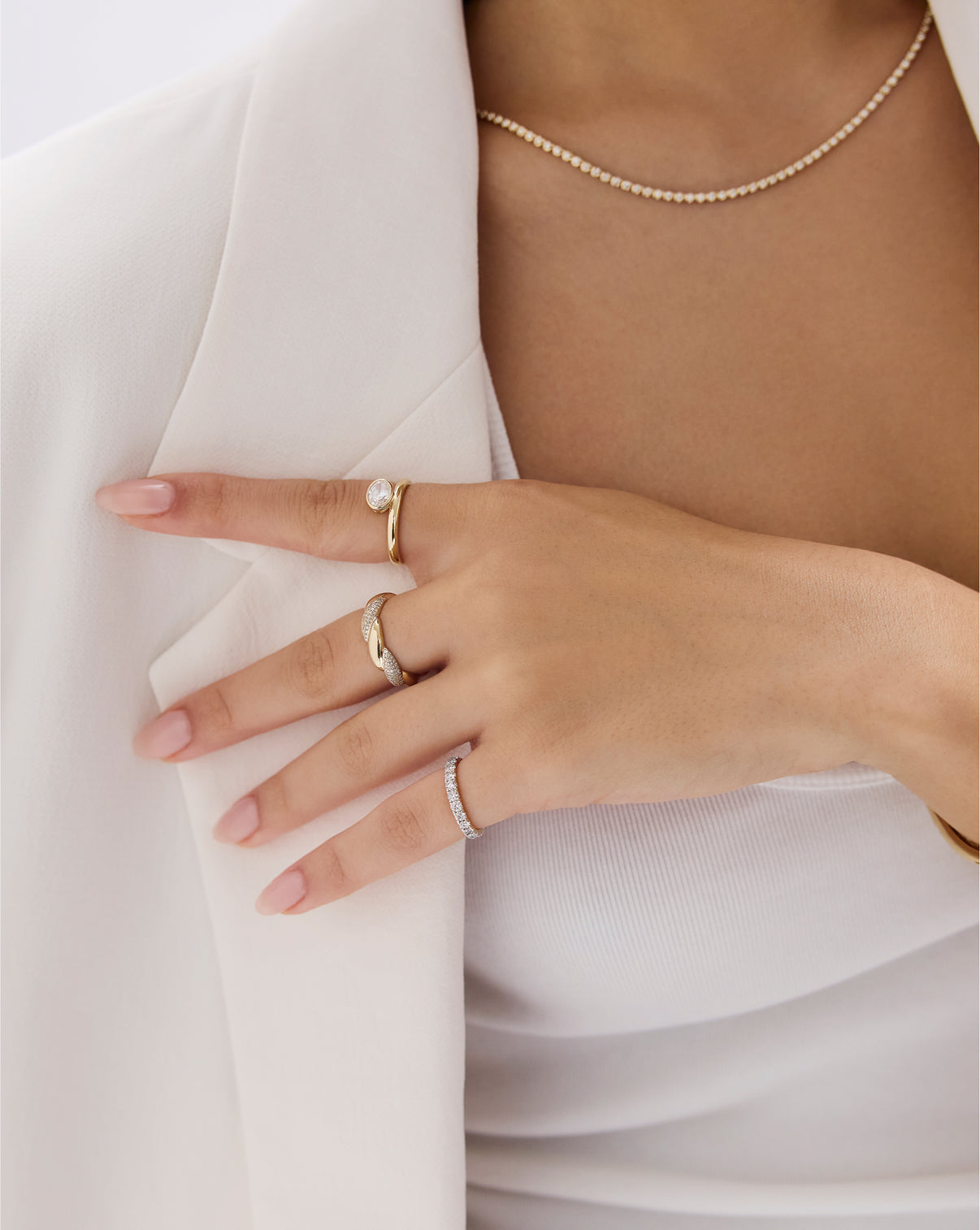 Oval bezel ring styled shot demonstrating the ring's sleek modern aesthetic and premium 14k yellow gold finish