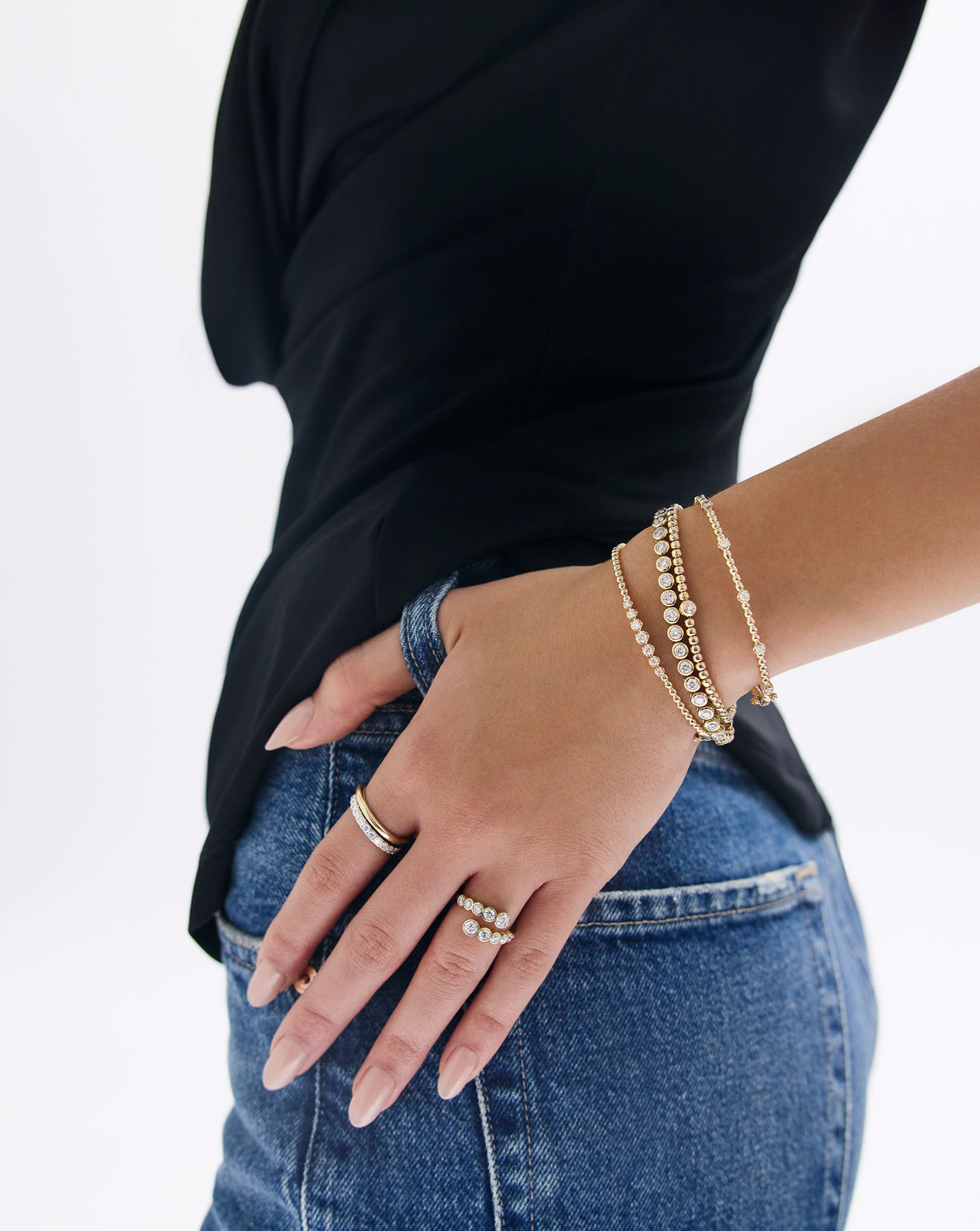 Bezel Diamond Tennis Bracelet worn on model's wrist showcasing elegant bezel -set stacked with other Ring Concierge  bracelets global