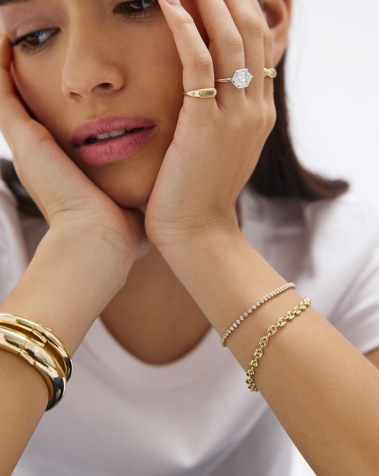 Close-up of model's hand wearing Bezel Mini Diamond Tennis Bracelet, highlighting the delicate bezel setting and diamond brilliance global