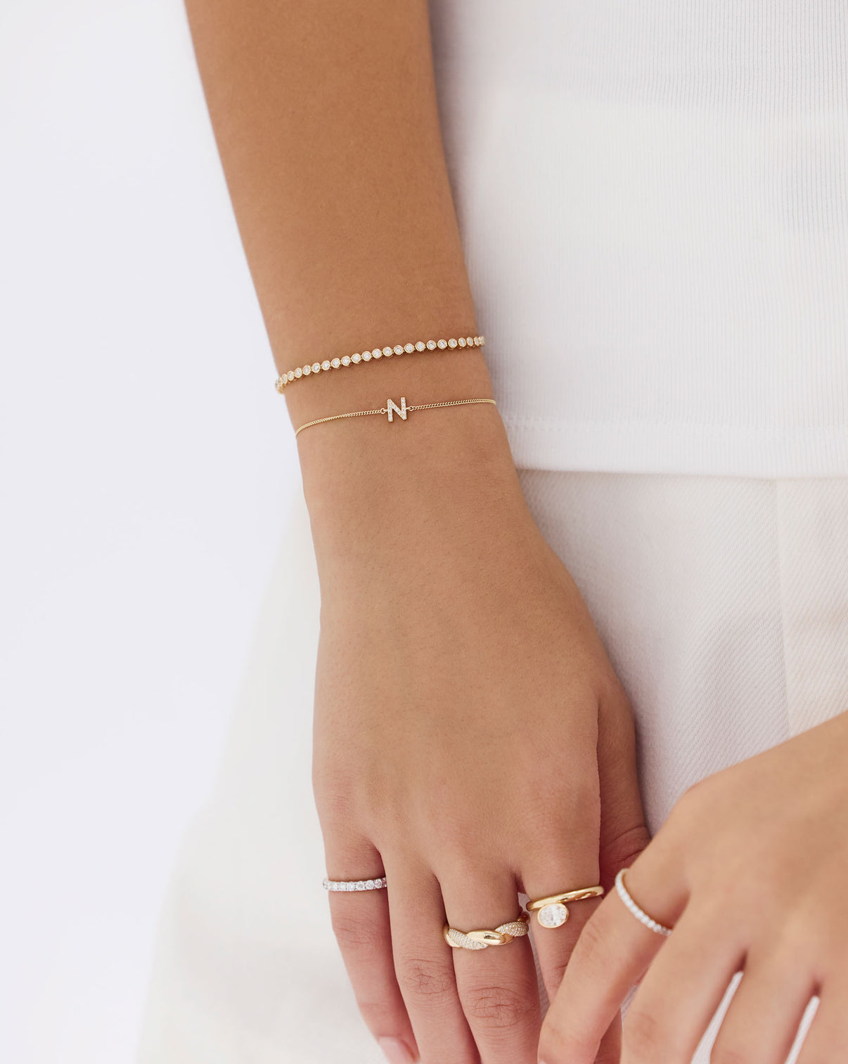 Profile shot of model wearing Bezel Mini Diamond Tennis Bracelet, showing how it complements the wrist naturally global