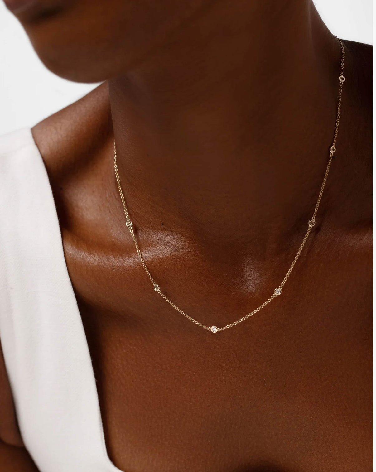 Side view of diamond bezel station necklace highlighting the bezel setting and chain detail