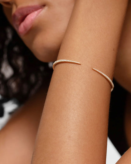 Model wearing Diamond Claw Cuff on wrist, demonstrating the perfect fit and sophisticated style of the gold and diamond bracelet