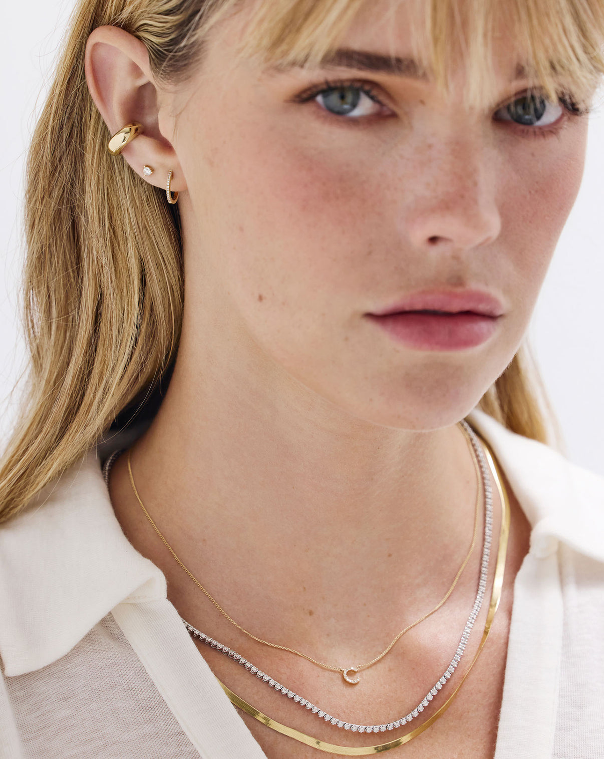 Diamond huggie earrings styled on model showing scale and wearability