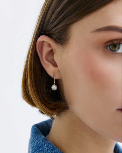 Model wearing Diamond and Pearl Drop Earrings in 14K Yellow Gold