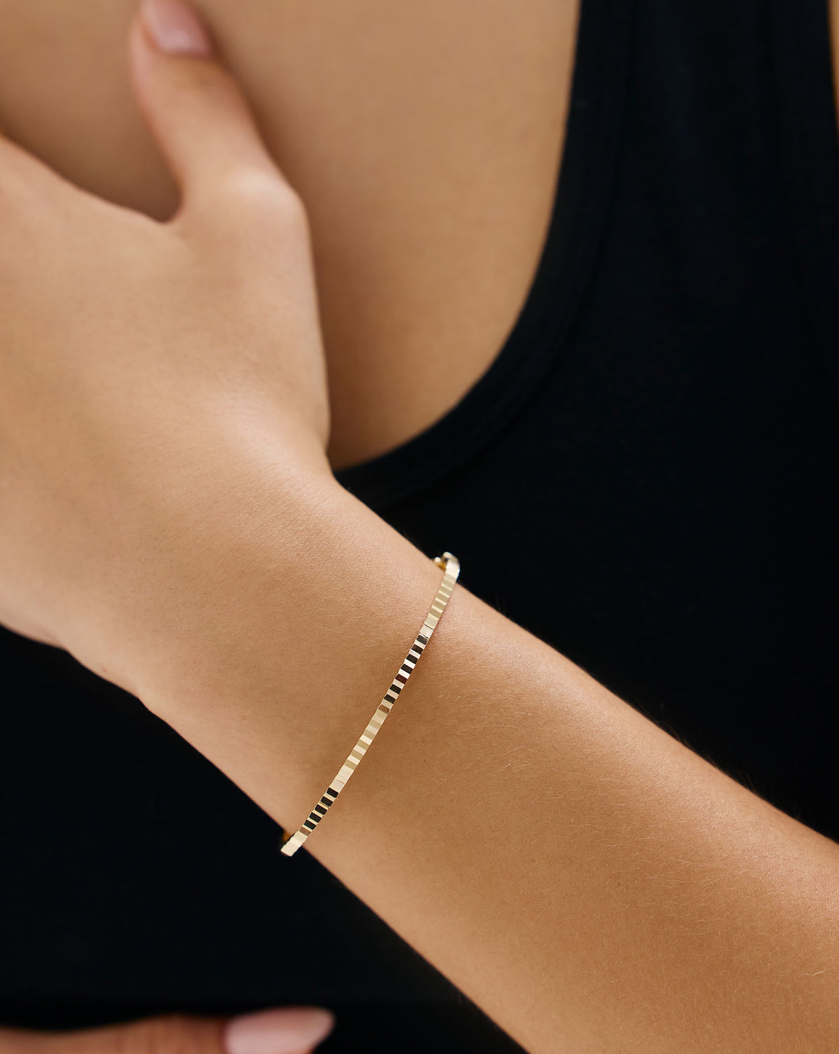 Lifestyle model shot featuring Fluted Gold Bangle - sophisticated gold bracelet styling