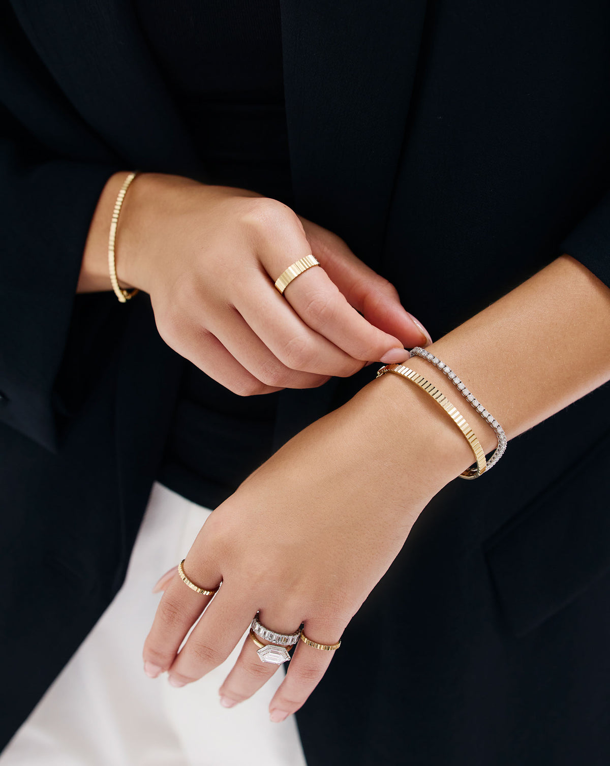Close-up of model wearing Fluted Gold Bangle - detailed view of ridged gold bracelet on wrist
