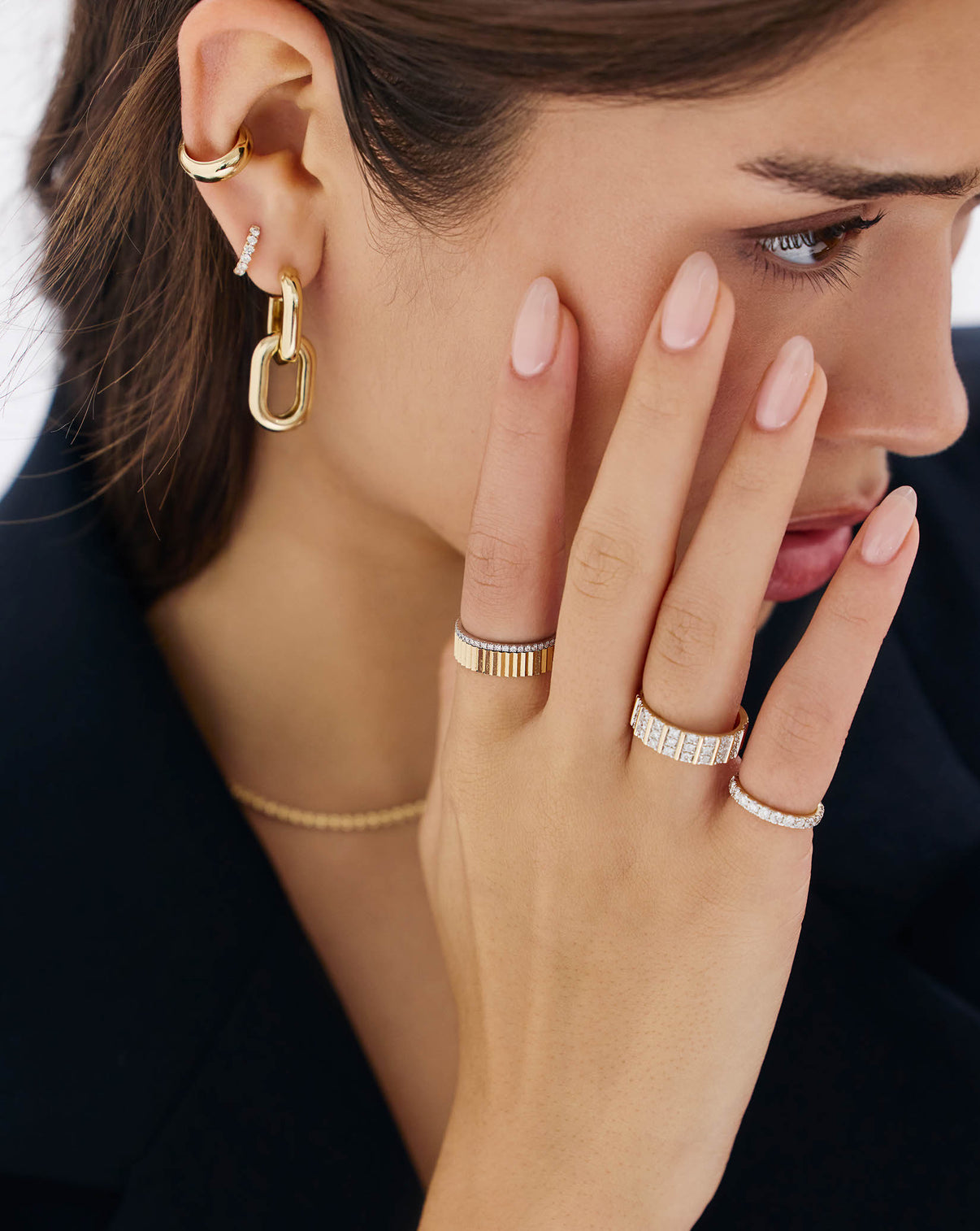 Model's hand showing classic Fluted Gold Stackable Ring paired with other jewelry GLOBAL