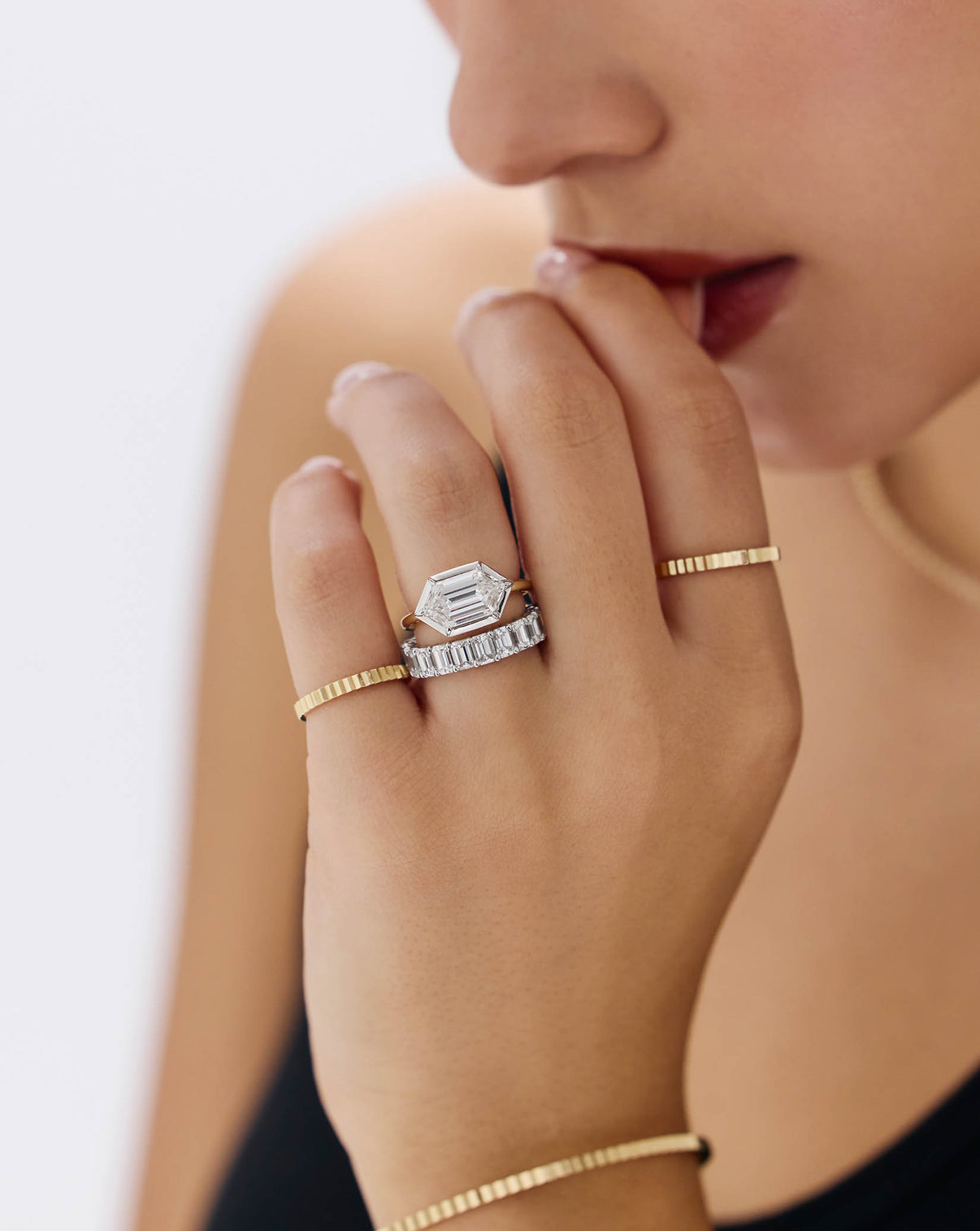 Close-up of model's hand showcasing slim Fluted Gold Stackable Ring GLOBAL