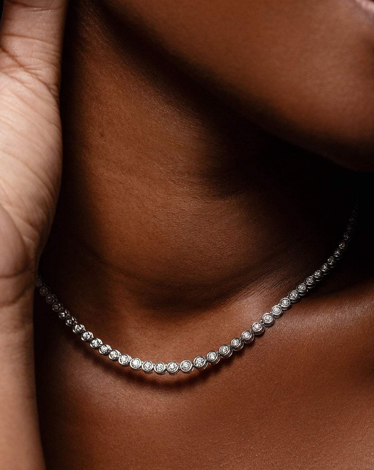 close up of graduated bezel tennis necklace GLOBAL