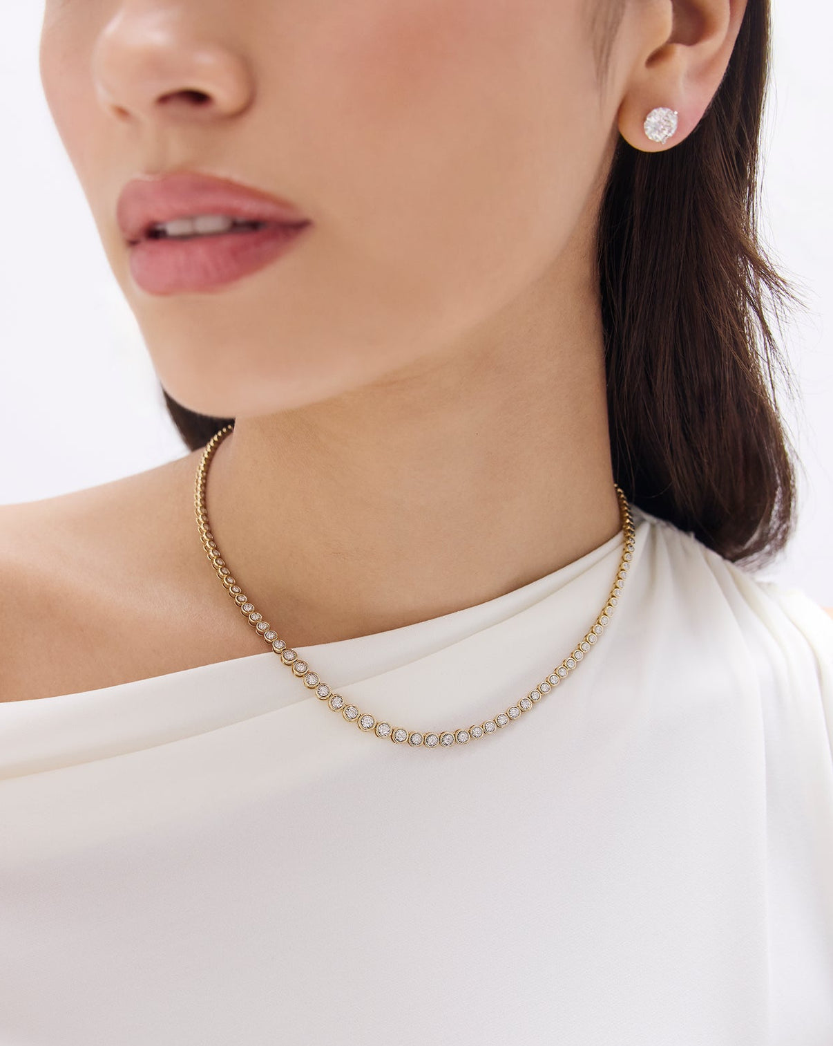 Side view of graduated bezel diamond tennis necklace displaying bezel setting detail and diamond graduation global