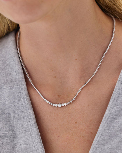 Close-up of model wearing Graduated Diamond Tennis Necklace, highlighting the natural G-H color diamonds and graduated sizing effect