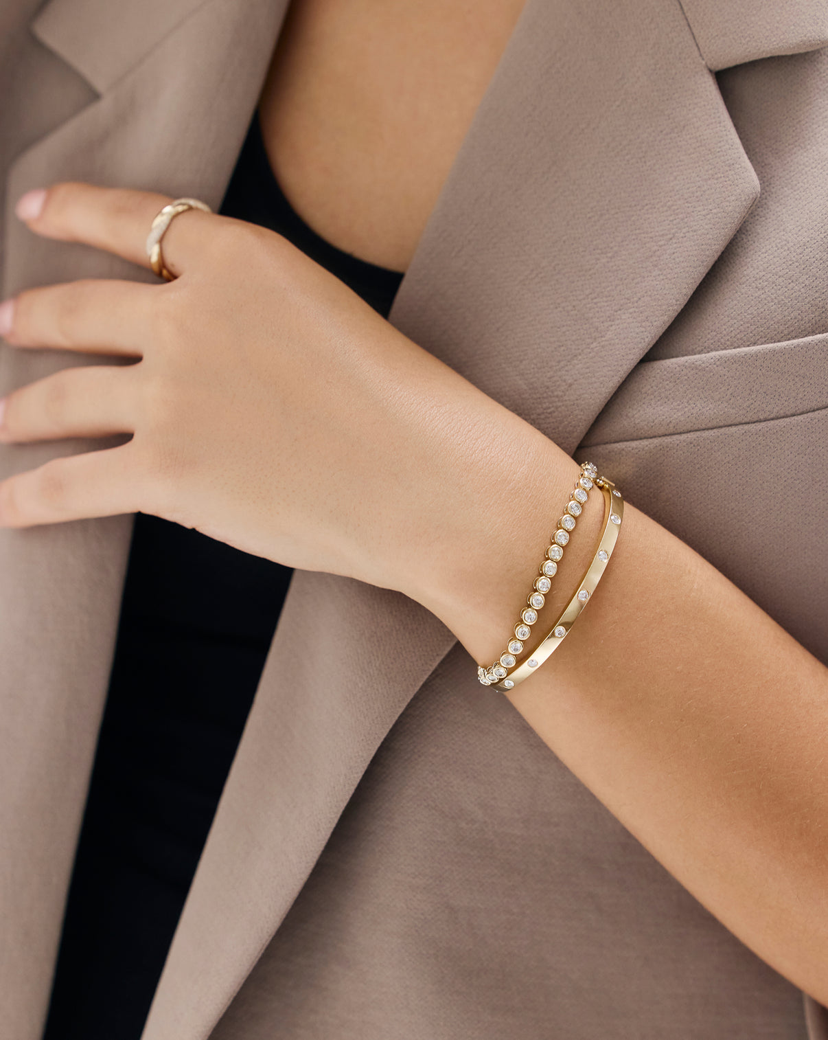 Model's hand showcasing Inlay Diamond Bangle in natural lighting, highlighting the diamonds' brilliance and fire global
