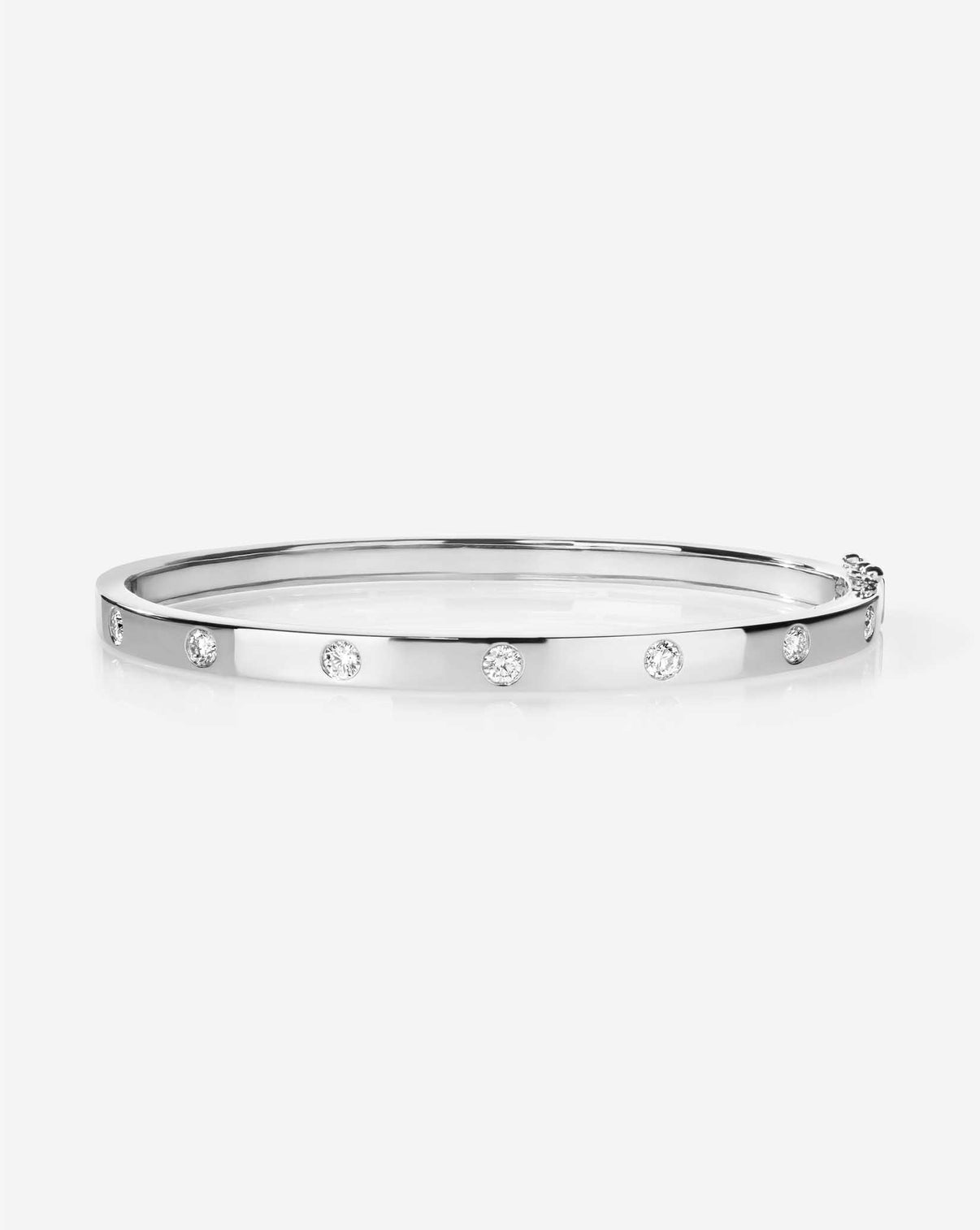 Overhead view of white gold Inlay Diamond Bangle displaying the circular pattern of inlaid diamonds and overall symmetry 14k white gold