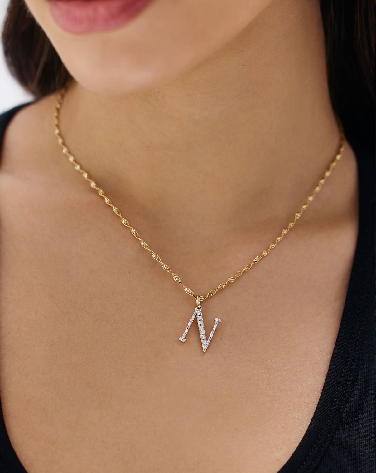 Model wearing large N pendant global