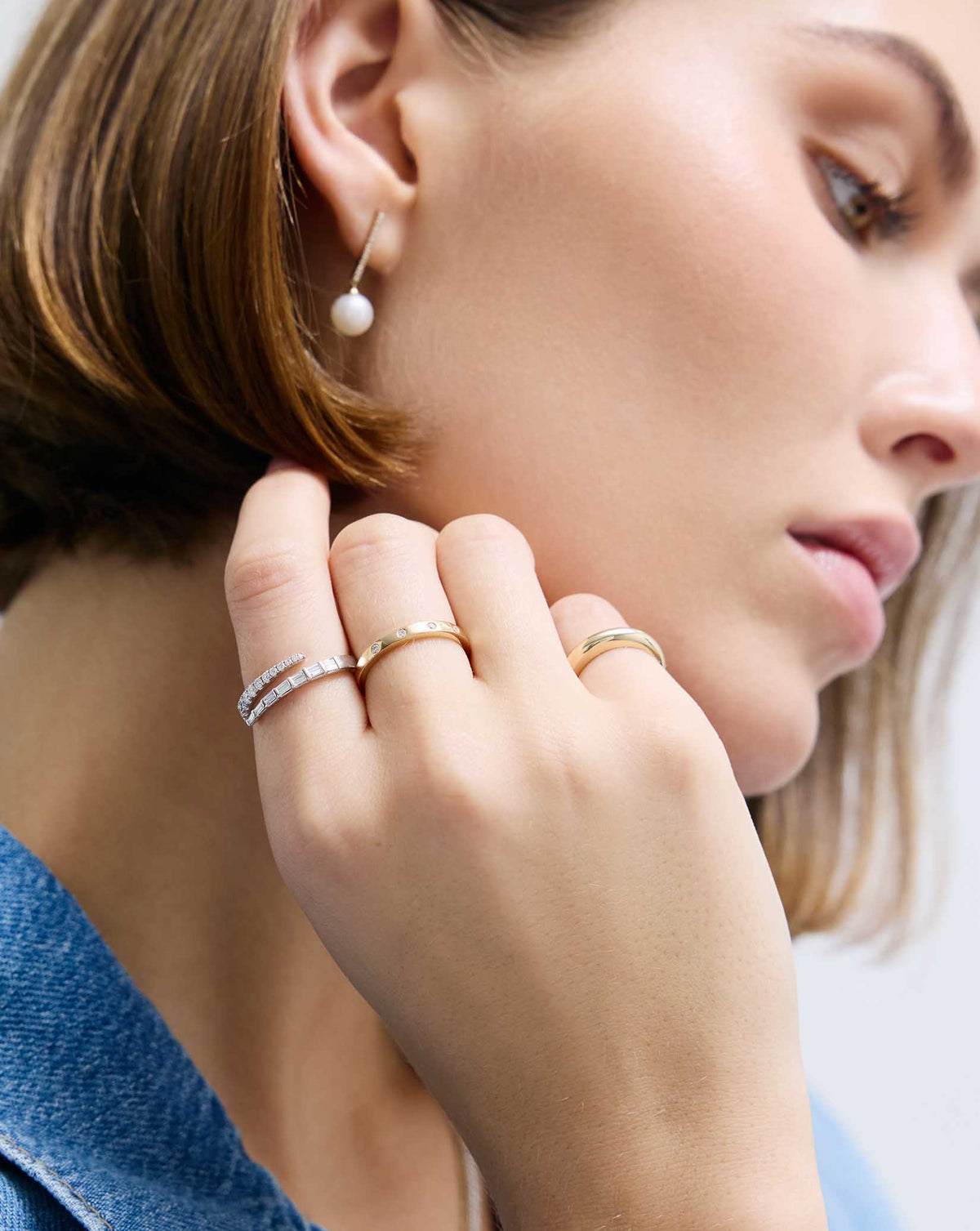Model wearing Luxe Open Diamond Wrap Ring in 14K White Gold and other rings