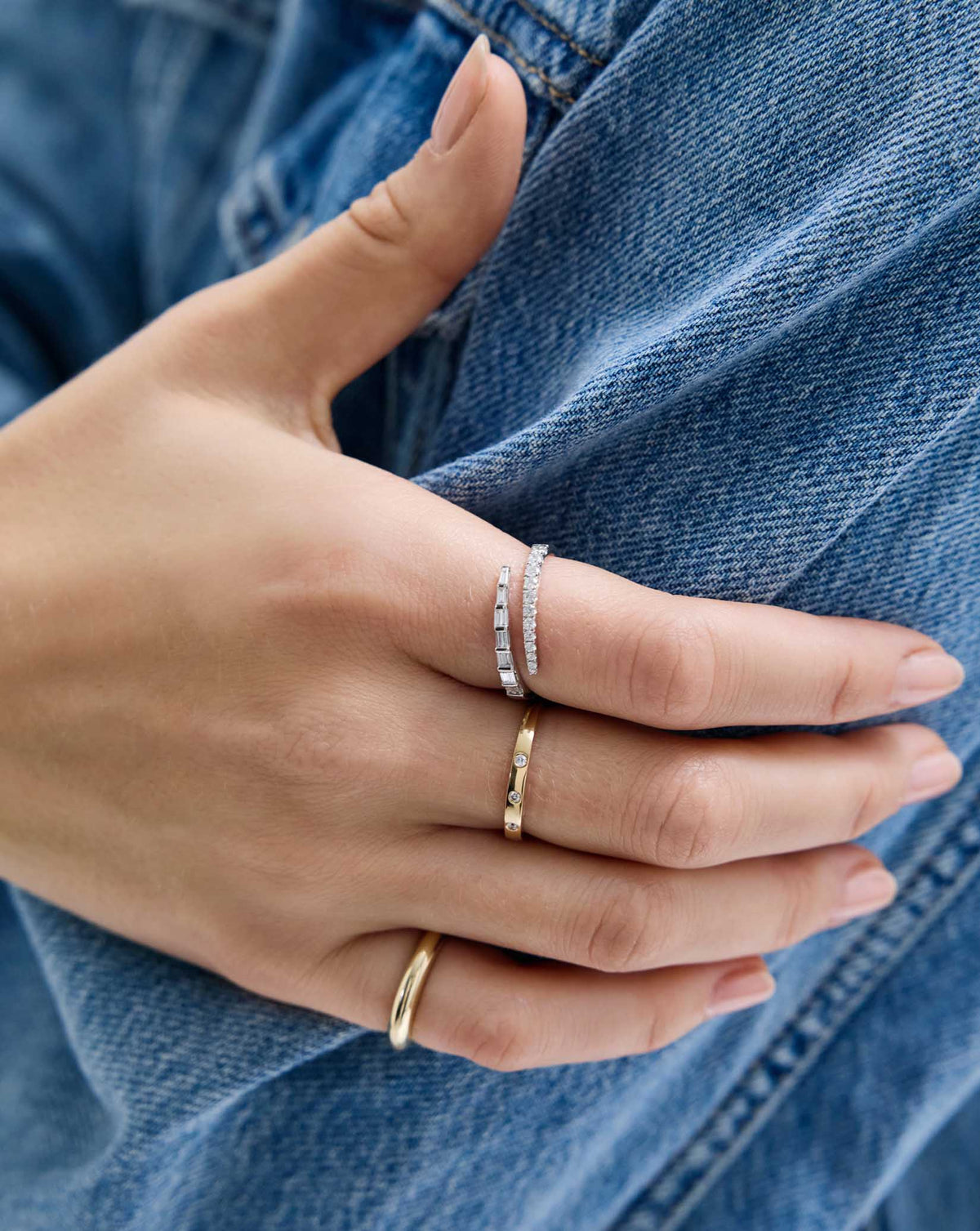 Model wearing Luxe Open Diamond Wrap Ring in 14K White Gold and other gold rings