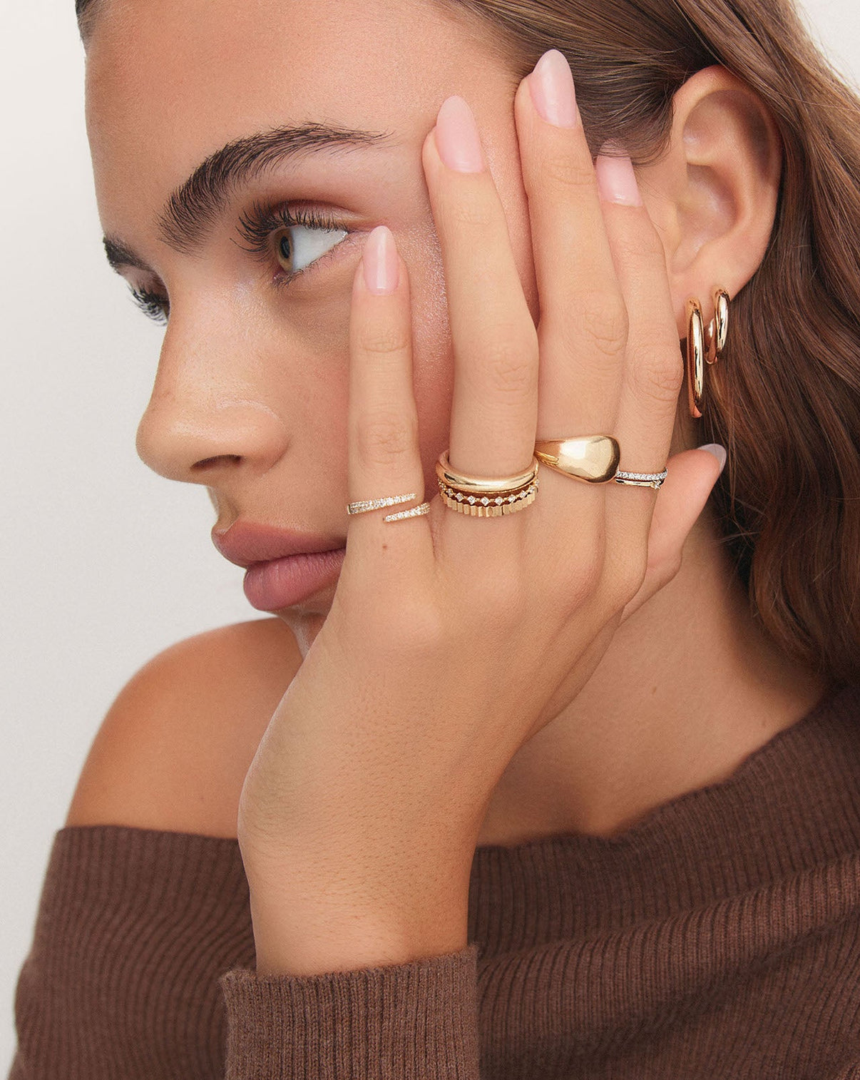 On model showing open diamond wrap ring styled with other key Ring Concierge styles GLOBAL