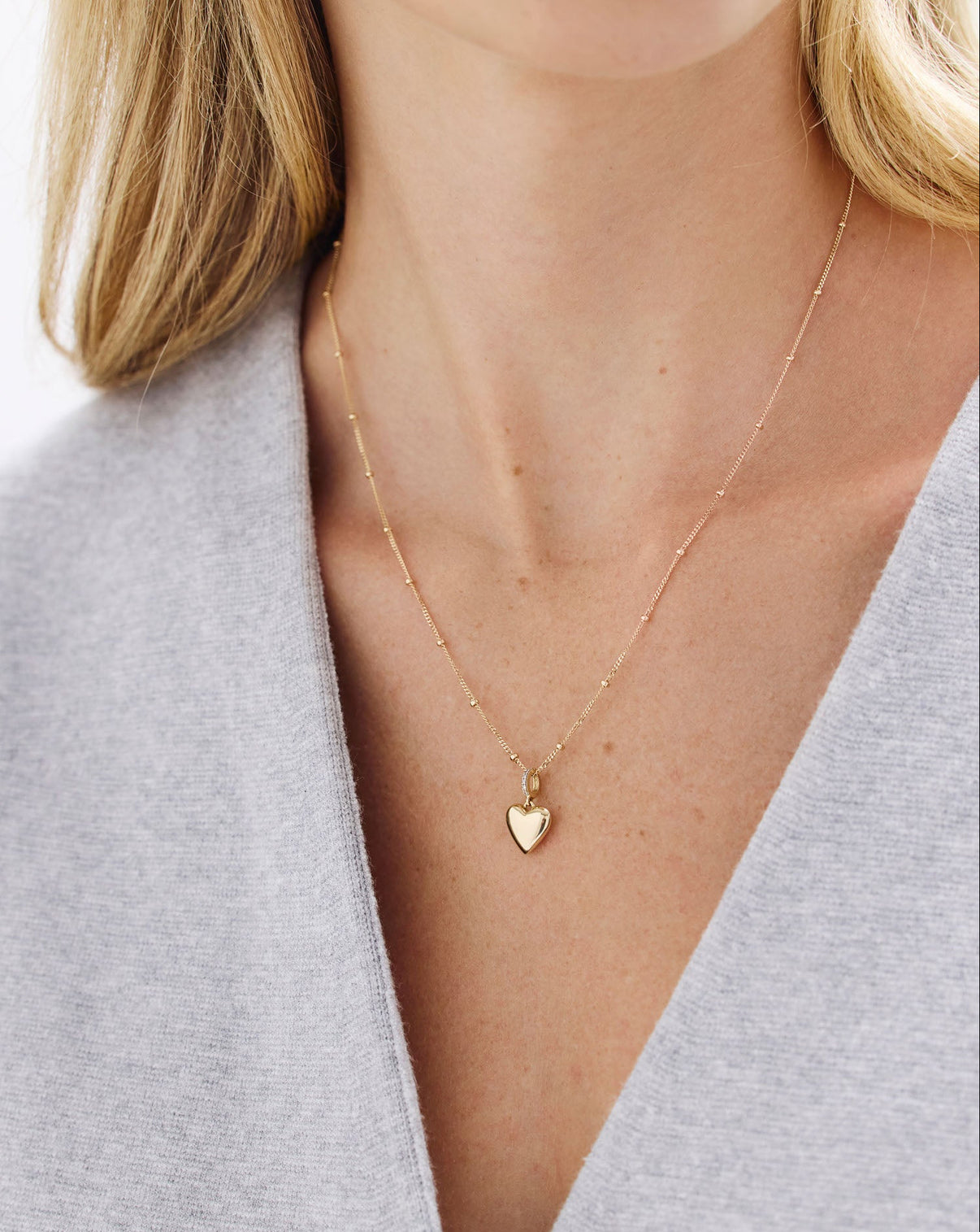 On-model image of chain necklace with heart charm