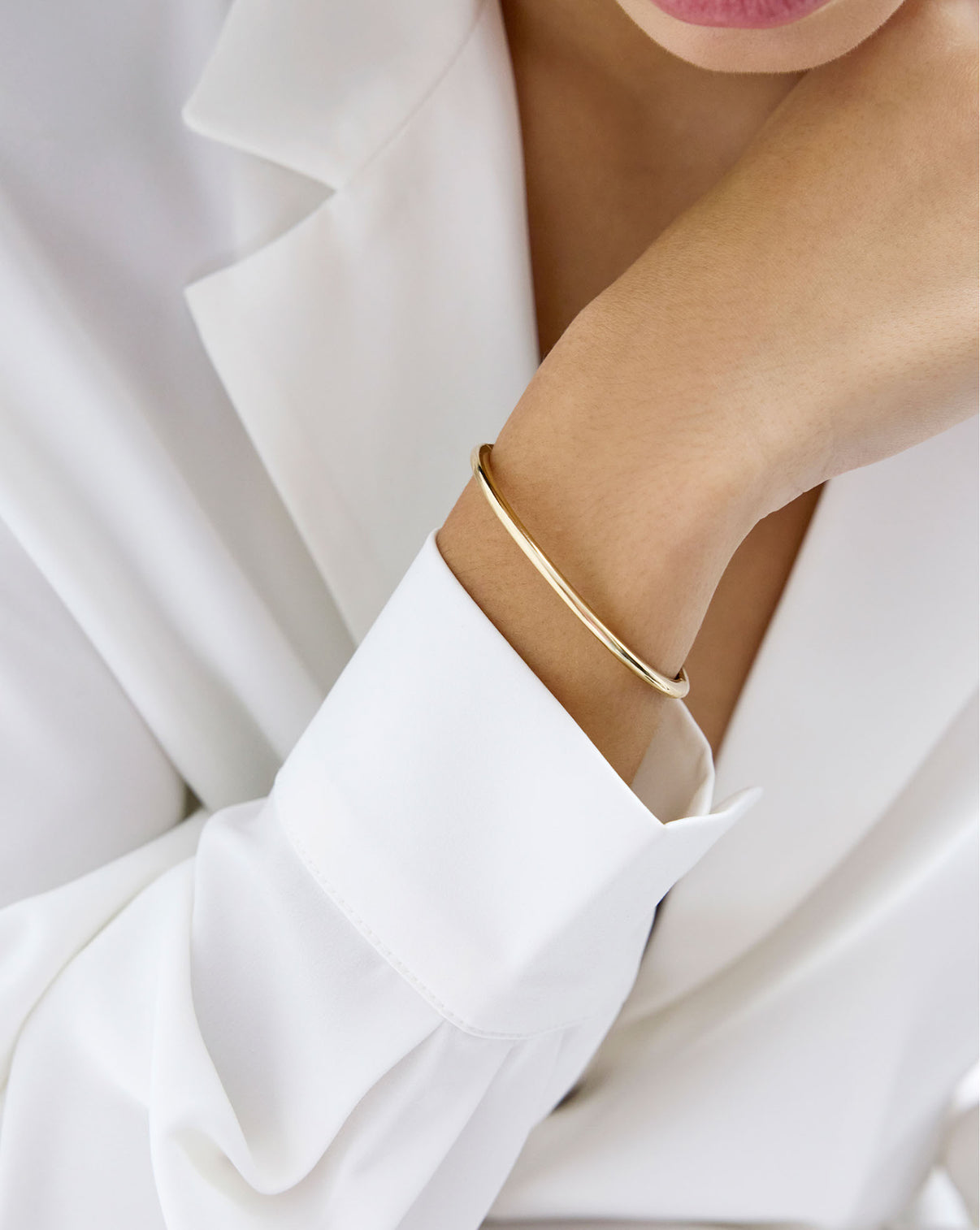 Slim Stackable Gold Cloud Bangle bracelet in 14k yellow gold shown on model's wrist